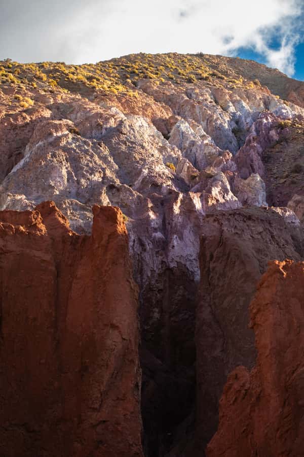 San Pedro de Atacama: Rainbow Valley & Hierbas Buenas Tour - Walking among red, green, ochre, and white hills